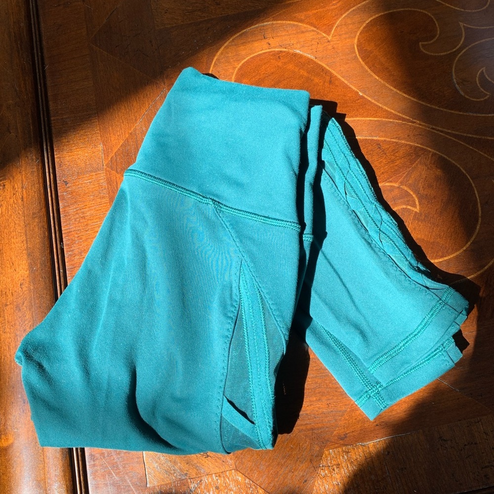 Teal Lululemon yoga pants with mesh details. Super flattering and cute!